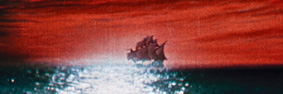 A large sailing ship (cutty sark type) on the horizon of a dark bue/black sea and red/orange sky.  The fading moon dappled on the sea in front of the ship.
