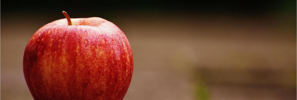 A close-up photograph of a red apple.