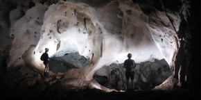 Two people stood in an underground cave.