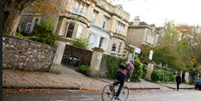 A cyclist passes the Victorian villas on Woodland Road