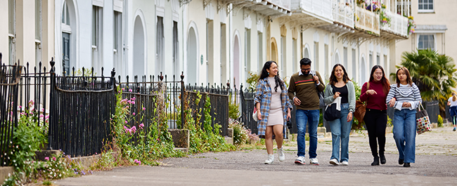 Five students walking together down a street in Bristol.