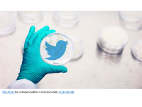 Image of hand holding petri dish with twitter bird in petri dish