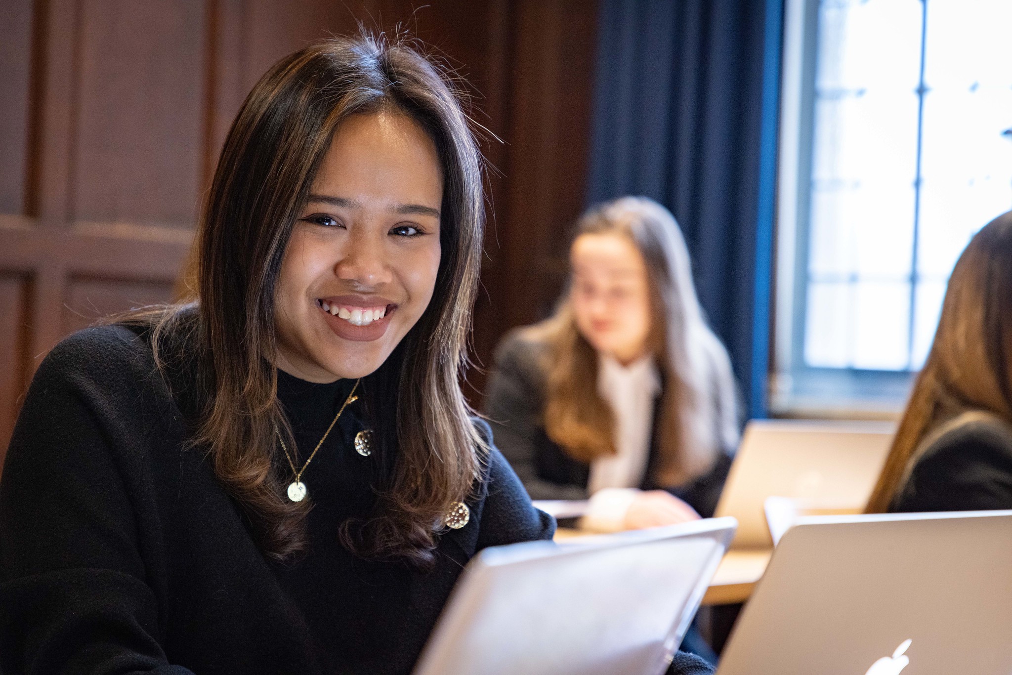 Female law student smiling using a laptop