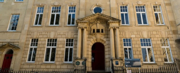 front of a building with columns either side of the door