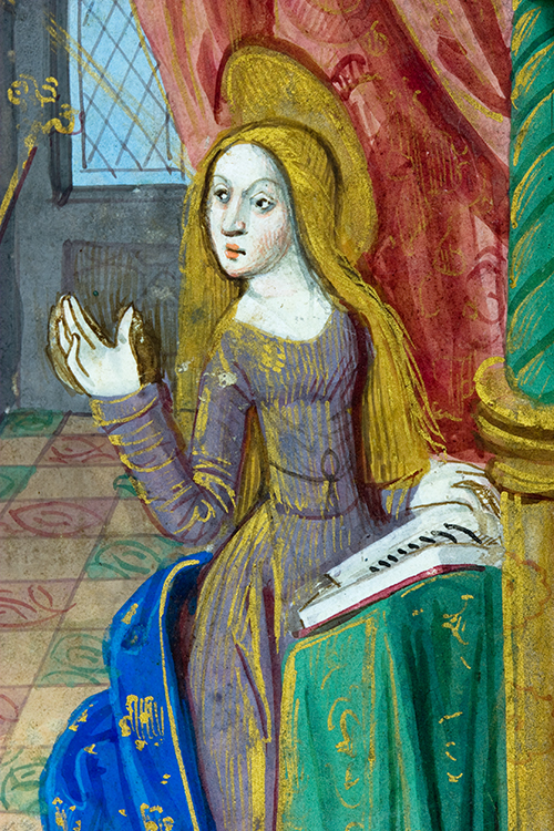 The Virgin Mary, sitting with a book and with raised hand.
