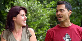 A woman and a man talking to each other and smiling.