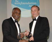 Dr Julian Hamilton-Shield (right) receiving his award from Mr Bernard Ribeiro, President of the Royal College of Surgeons of England