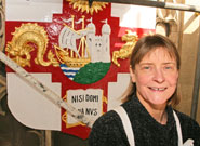 Artist Phillipa Fawcett with the newly repainted University of Bristol coat of arms