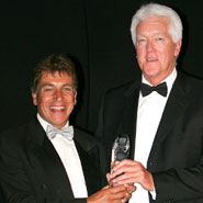 Image of Gordon (right) receiving his award from BUSA President, John Inverdale (left)