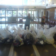 An image of SCA Volunteer, Grace Banks with bags of items ready to donate to charity.