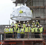 The buckyball is lowered into place