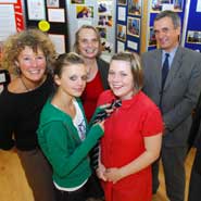 An image from left to right of: (front) pupils Katy Snook and Cher Dyer trying on the new school tie (back row) Vicky Stinchcombe and Professor Rosamund Sutherland from the University of Bristol's Graduate School of Education and Principal of the new Withywood Merchants' Academy, Stephen Kings