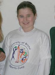 An image of competition winner Chloe Beresford wearing her prize, the T-shirt bearing her new logo.