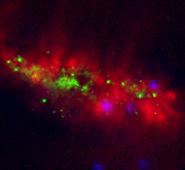 (fig 2) False colour mosaic showing the Subaru COMICS image (red), a Hubble Space Telescope near-infrared image of stars (green) and a Chandra satellite X-ray image (blue) dominated by extremely hot gas and black holes