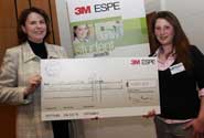 Laura Cove (right) receives her prize from Mary Anstice, General Sales and Marketing Manager for 3M ESPE