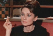 Actress Audrey Hepburn smoking in the film Charade