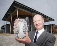 The Rt Hon David Willetts, Minister of State for Universities and Science, with a glass sculpture of the smallpox virus