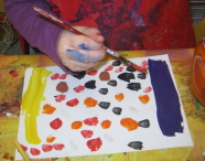 A child from St Werburgh’s Park Nursery School and Children’s Centre tries their hand at painting for the exhibition