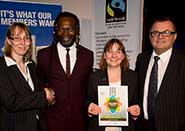 Annabel Hurst, Linda James and Fred Quinn receive their award from chef Levi Roots