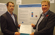 Tomos Edwards (left) is awarded first prize for his poster presentation by Chris Head, CEO of Meningitis Research Foundation
