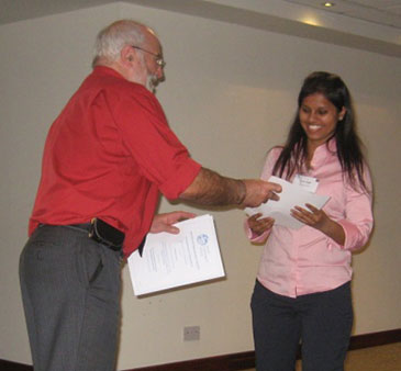 Tanu Singh receiving her prize from Nigel Goody, President of British Hydrological Society