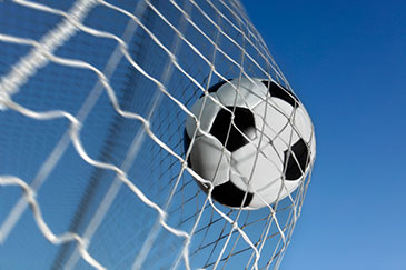 Image of a football hitting the back of the net