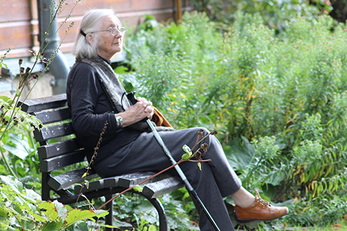 An elderly woman sat on a bench