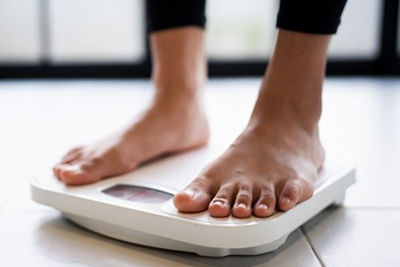 A person stood on weighing scales