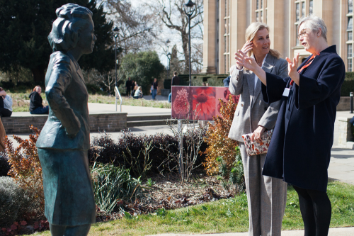 Professor Judith Squires, Deputy Vice-Chancellor with HRH The Duchess of Edinburgh discussing the life-size bronze statue of Henrietta Lacks, a Black American woman whose cells were the first ever to survive and multiply outside the body, and whose use changed the course of modern medicine.
