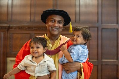 Photograph of Krish Majumdar with his twin boys at his graduation