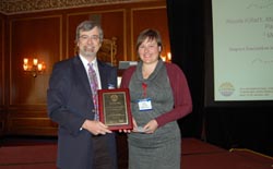 Steve Mahon of CSMantech awards Nicole Killat her prize