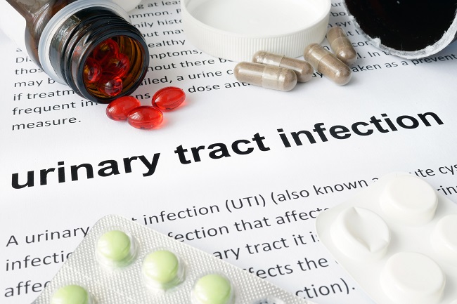 Dictionary entry for 'urinatry tract infection' surrounded by antibiotic tablets.