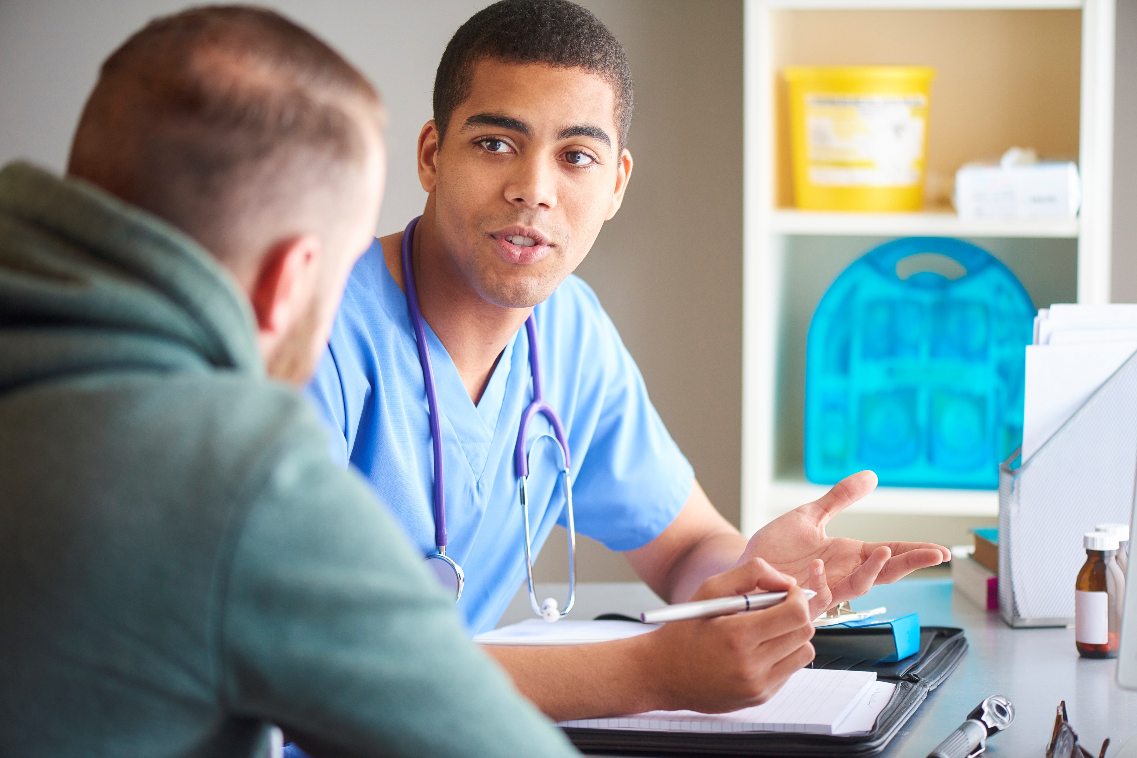 A paramedic consulting a patient