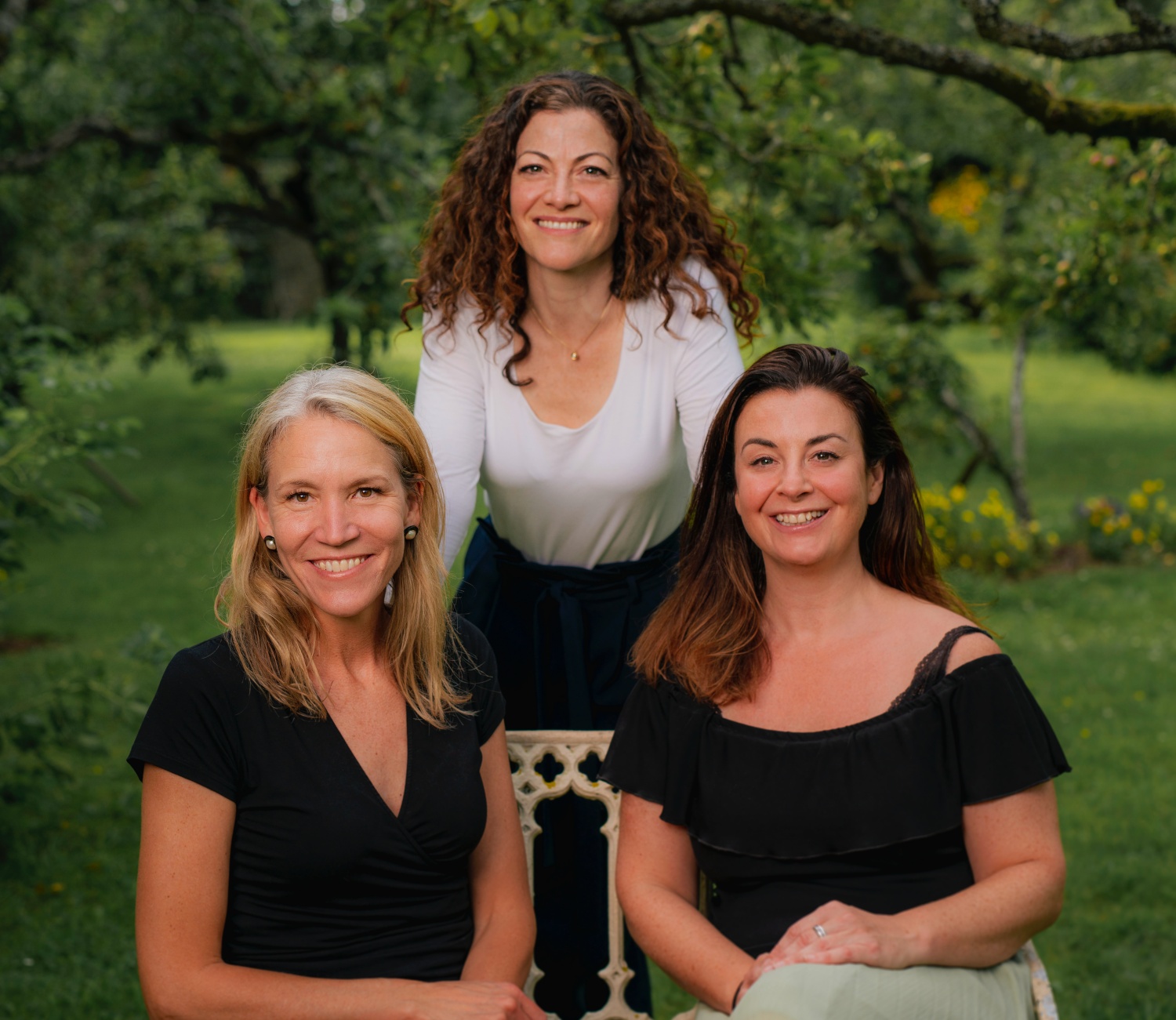 Dr Lucy Selman, Dr Lesel Dawson and Aisling Mustan group photo in a green and leafy setting