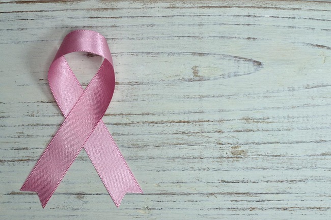 Pink ribbon cancer symbol on a grey background