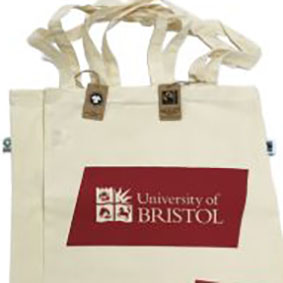 University of Bristol branded tote bag Red printing onto a natural colour bag made from Organic cotton and Fairly traded with long handles