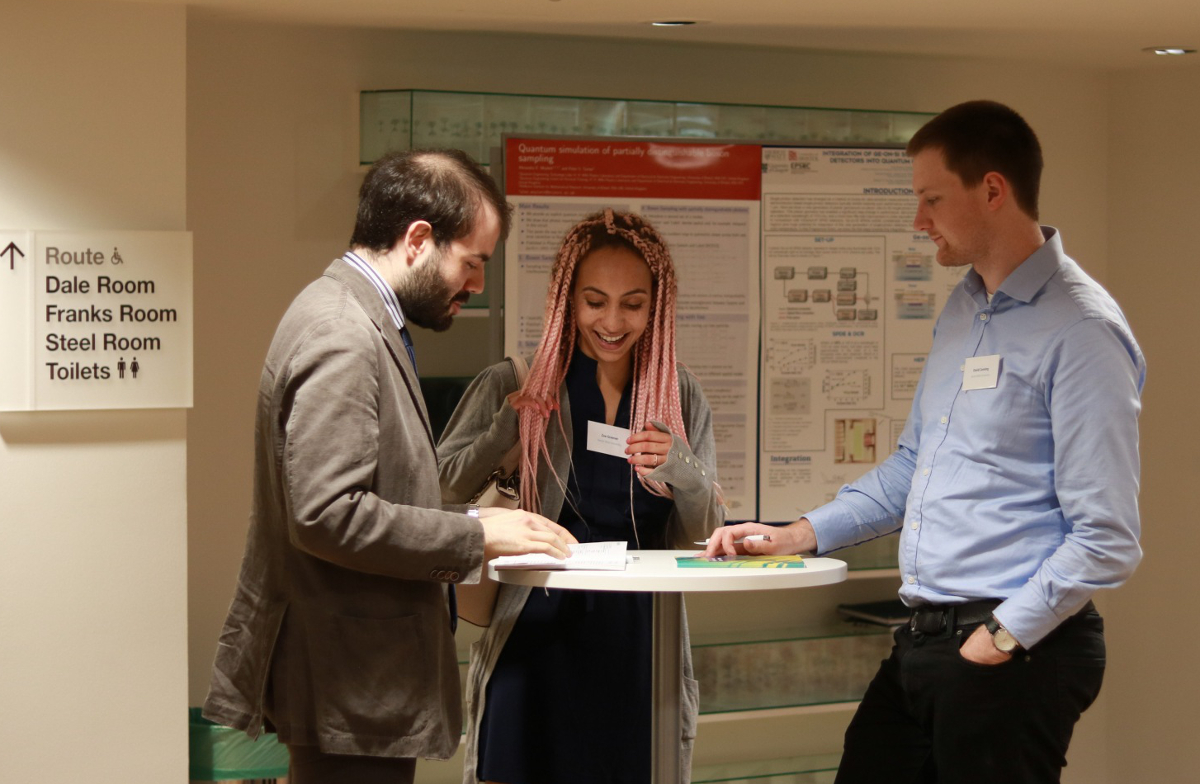 Image of poster session at EPQT event; Zoe Greener and Ugo Zanforth from Heriot-Watt