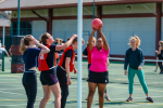 Image of adults playing netball outdoors