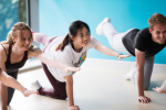 Image of three adults in a studio fitness class