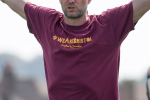 Man wearing a maroon '#WeAreBristol' cotton t-shirt with yellow writing on the front
