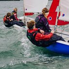 4 people wearing life jackets sailing two dinghies. Image links to sailing club page on Bristol SU Website.