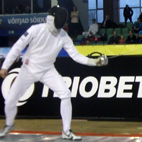 Student in fencing gear, fencing in competition. Links to fencing club page on Bristol SU Website.