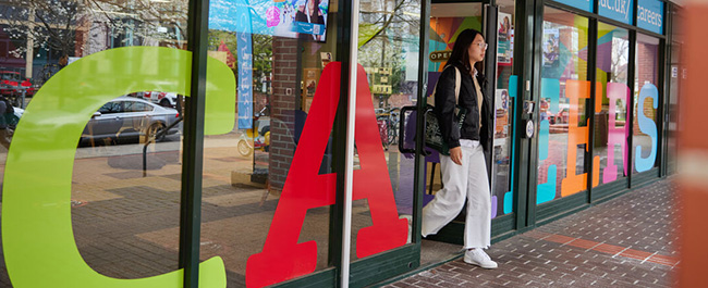 A female student walking out of the careers service building