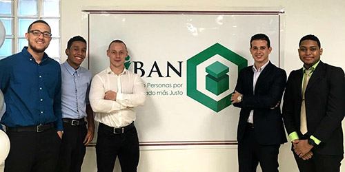 Marc-Anthony stands in front of the IBAN logo