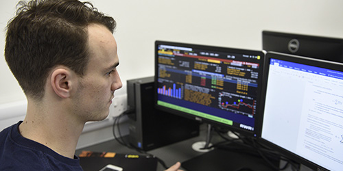 A student works in the financial trading computer room using Bloomberg Professional software