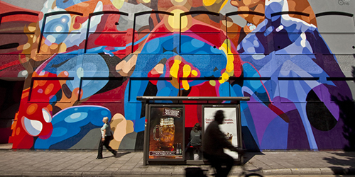 A large piece of colourful street art on a building.