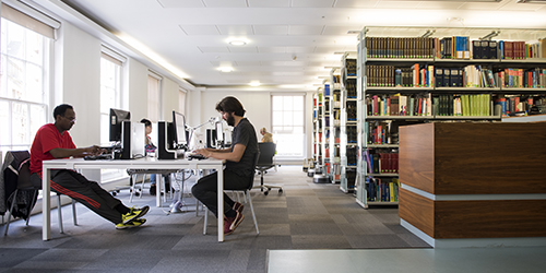 Students working at computers in a library.