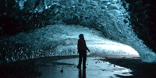 A person stands in an ice cave.