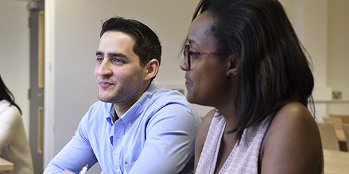 Two people working in a classroom.