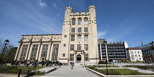 The exterior of a large, grand stone building.